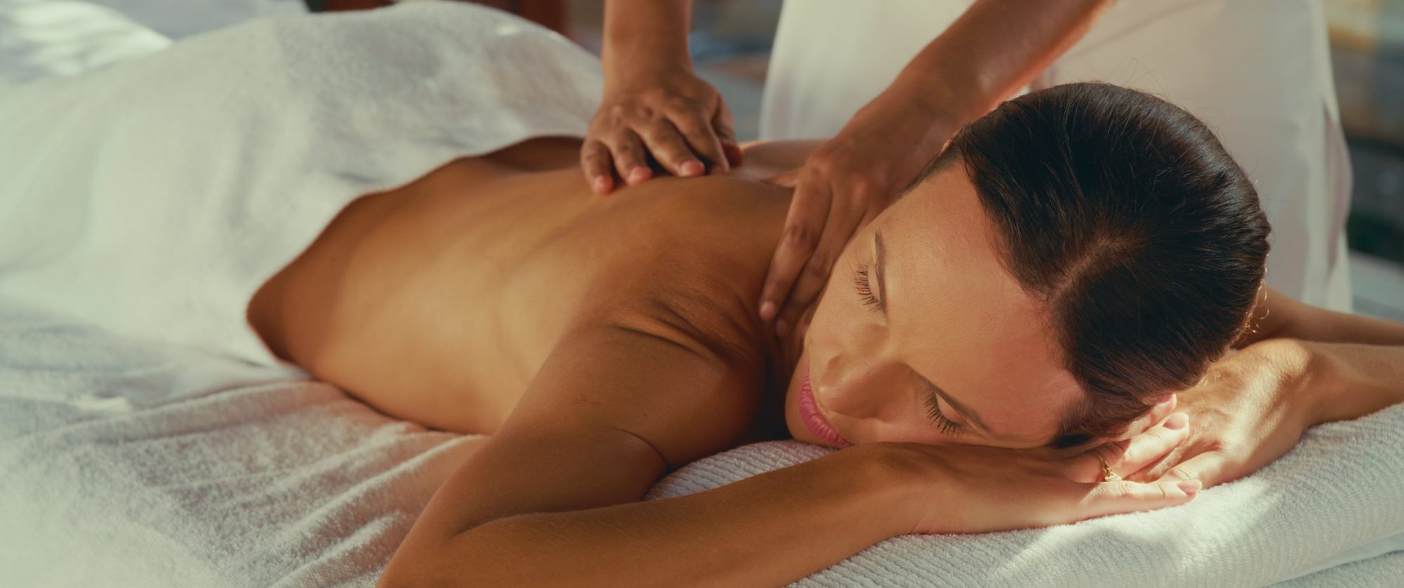 A woman relaxes during a spa massage